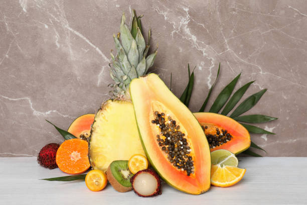 istock Ripe exotic fruits against gray textured background 2075239435