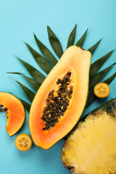 istock Ripe fresh exotic fruits on blue background 2075239997