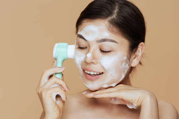 istock young asian woman with massager washing face 2075280476