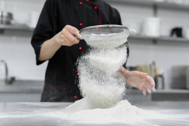 istock The pastry chef's hands sift the flour through a sieve on the table 2075285862