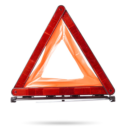 Warning stop sign made of red reflective plastic with a blue case on a white isolated background in a photo studio. Mandatory device for being in the car. Spare part for sale on auto parsing.