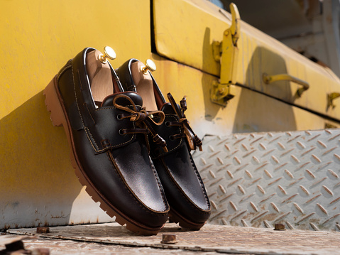 Men fashion boat shoes leather on the ground.