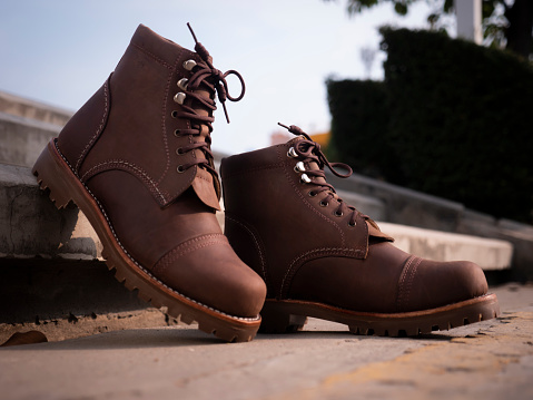 Man fashion brown boot leather on the ground.