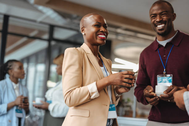 istock Colleagues laughing and networking during coffee break at business conference 2075325479