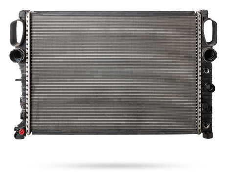 Car cooling radiator isolated on white background. Spare cooling system of internal combustion engine