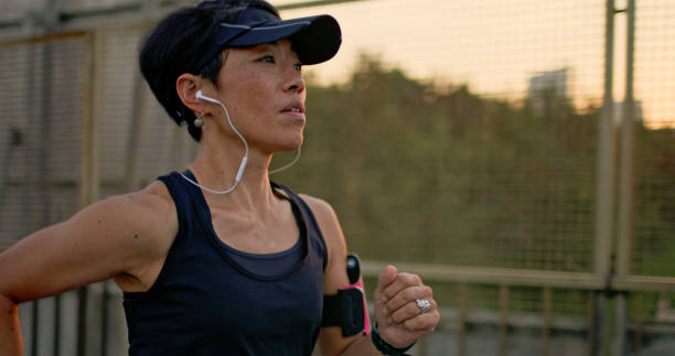 istock Athletic woman running on street 2075338396