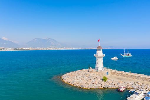 Alanya lighthouse aerial drone view with port and city. Alanya, Turkey.