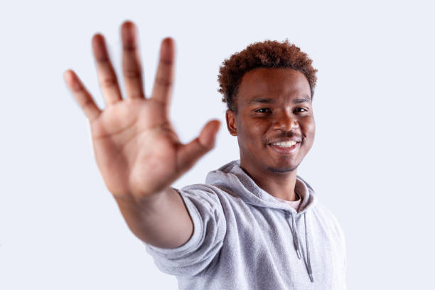 Portrait of young men making hand sign