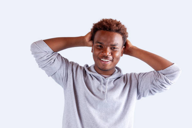 istock Portrait of young men hands behind head 2075359500