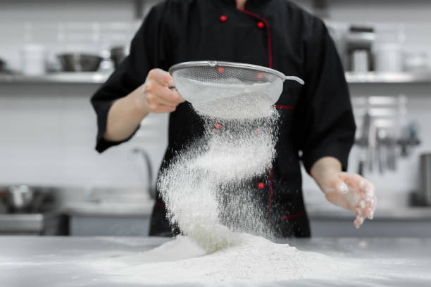 istock The pastry chef's hands sift the flour through a sieve on the table 2075360043