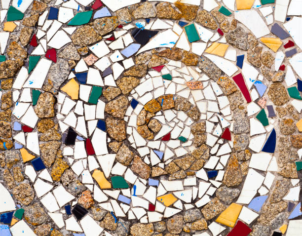 Multicolored mosaic dragon salamander of Gaudi in Park Guell, Barcelona, Spain. Flat Pink background.