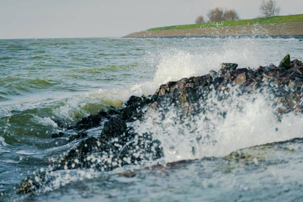 Stormy waves along the coast of the UNESCO Wadden Sea at the old VOC harbor of the village 'Oudeschild' on the island of Texel, Netherlands