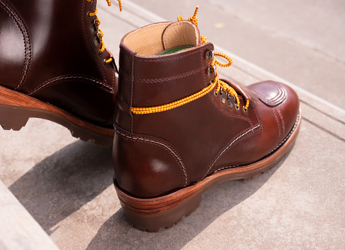 Man fashion brown boot leather on the ground.