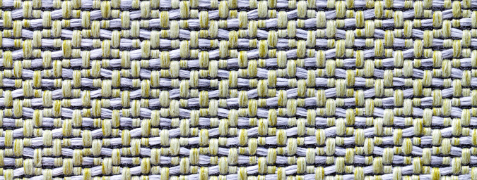 Texture of white and green color background from woven textile material with wicker pattern, macro. Structure of vintage fabric cloth, narrow backdrop.