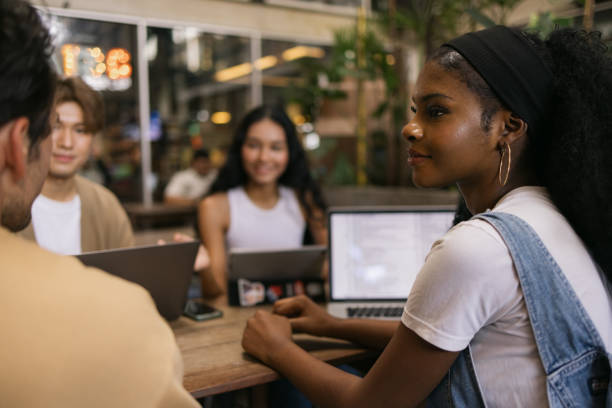 istock Smiling black student talking to her friends at campus. 2075383769
