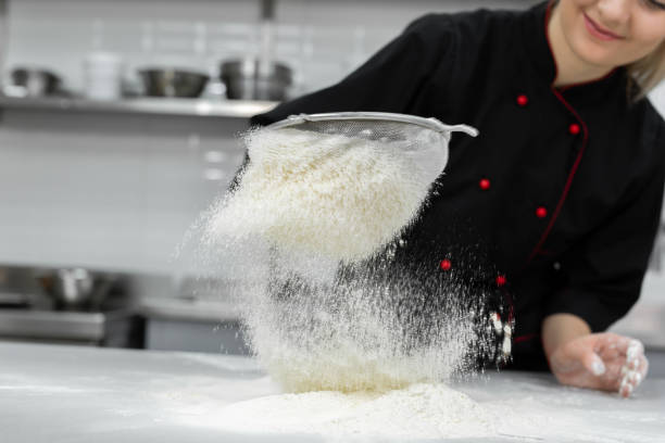 istock The pastry chef's hands sift the flour through a sieve on the table 2075384305