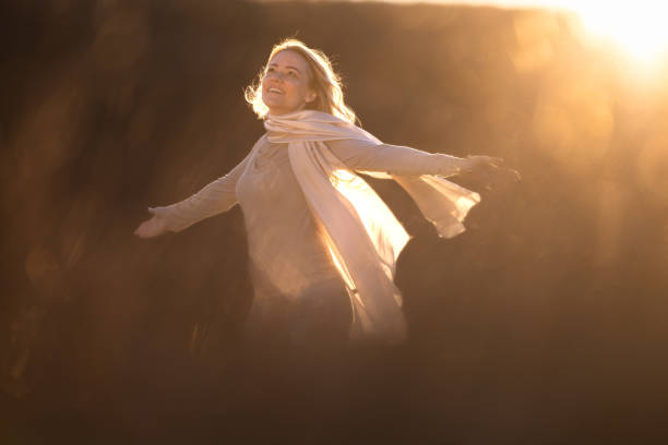 istock Happy woman spinning in nature during sunset 2075398279