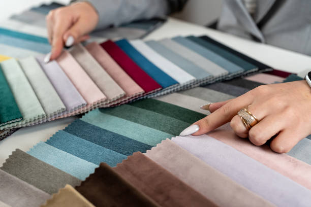 istock close up female designer hand choosing fabric among colorful samples at office 2075428270