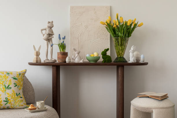 istock Spring and easter composition of living room interior with mock up poster frame, pouf, flowers, tulips, easter decorations and elegant accessories. Template. 2075428804