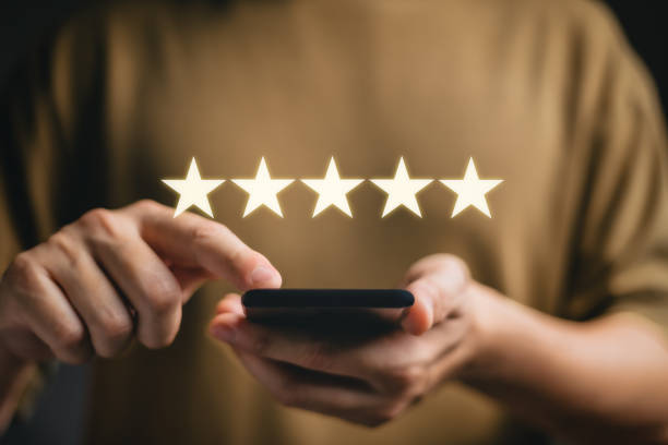 istock Customer service experience and business satisfaction survey, close up Woman hand using smart phone and give five star symbol to increase rating of product and service concept. 2075429321
