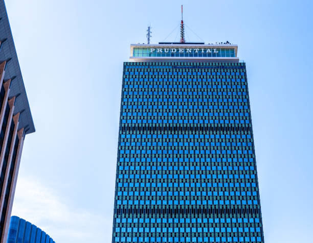 Prudential Tower - Back Bay - Boston Massachusetts Boston, Massachusetts, USA - March 8, 2024: The top of the Prudential Tower, also known as the Prudential Building or The Pru. It is an international style skyscraper in Boston, Massachusetts. The building, a part of the Prudential Center complex, currently stands as the 2nd-tallest building in Boston, behind 200 Clarendon Street, formerly the John Hancock Tower. The Prudential Tower was designed by Charles Luckman and Associates for Prudential Insurance. Completed in 1964, the building is 749 feet (228 m) tall, with 52 floors, and (as of January 2021) is tied with others as the 114th-tallest in the United States. boston prudential building stock pictures, royalty-free photos & images