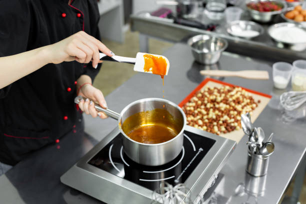 istock Steel pot with boiling caramel for making pralines. 2075431985