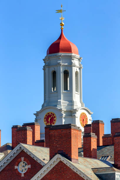 Cambridge, Massachusetts, USA - February 25, 2024: Close-up of Harvard University's Dunster House clock tower and cupola. Dunster House is an undergraduate residence located on the banks of the Charles River next to the John W. Weeks Footbridge. Built in 1930 and named after Henry Dunster, first president of Harvard University.