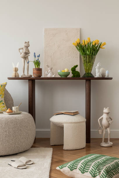 istock Spring and easter composition of living room interior with mock up poster frame, pouf, flowers, tulips, easter decorations and elegant accessories. Template. 2075437363