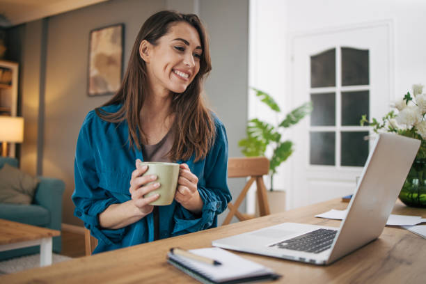 istock Beautiful attractive woman using laptop and drinking coffee. 2075447549