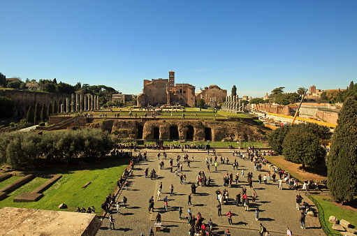 View looking down from Colosseum onto Palatine Hill with many tourists walking around -  Rome, Italy