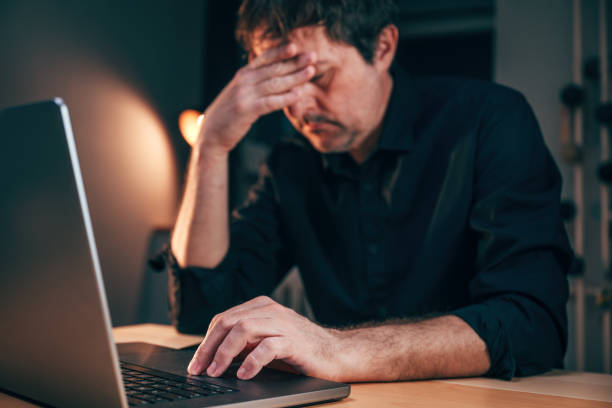 istock Common laptop malfunction problem giving a headache to a businessman while working overtime 2075449579