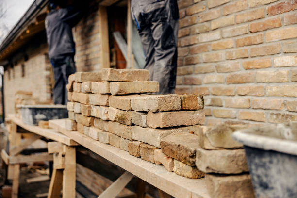 istock Selective focus on pile of bricks on a scaffolding with builders making a house. 2075450730