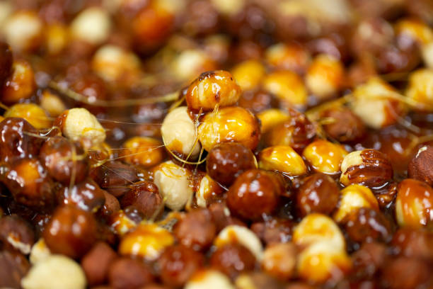 Delicious sweet hazelnut nuts in sugar caramel. Preparation of desserts in a pastry shop from natural ingredients.