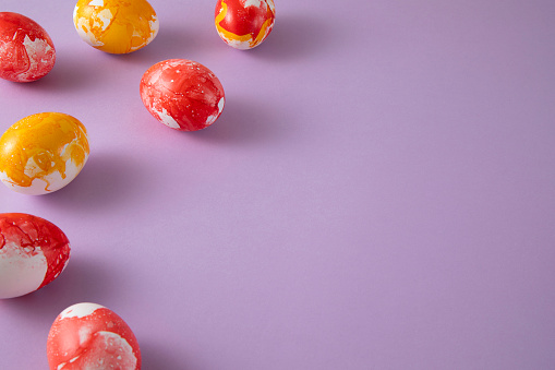 Hand colored colorful easter eggs on purple background