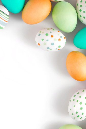 Group of colorful easter eggs on white background with copy space