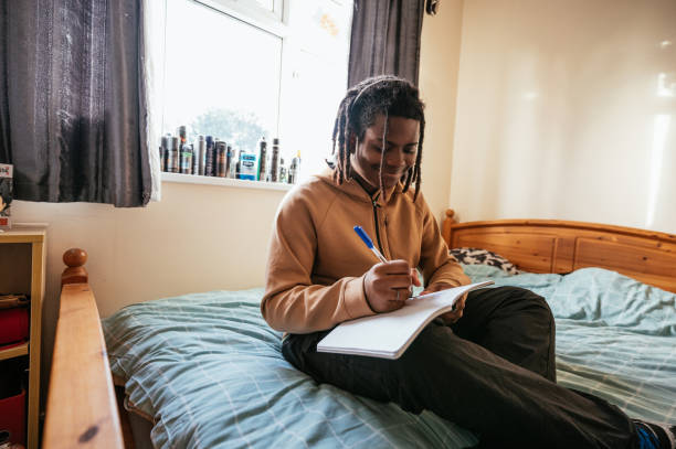 istock Teenager at home doing homework in his room 2075454557
