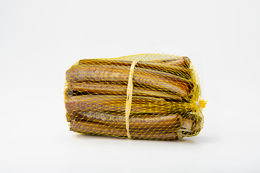 Fresh razor clams, neatly packaged in a mesh, ready for consumption.