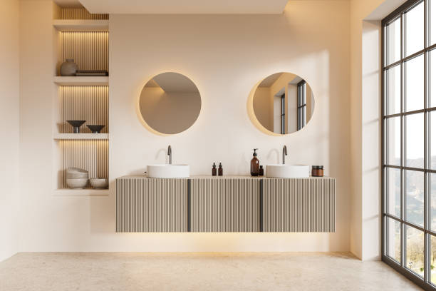istock Beige home bathroom interior with double sink and vanity, panoramic window 2075484947