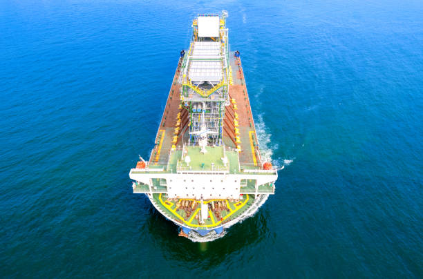 top view logistics and transportation large cargo ship transporting loads of oil rig parts  oversized cargo transportation - floating oil production platform foto e immagini stock