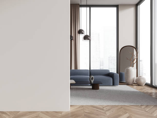 istock White living room interior with blue couch and blank wall 2075500859
