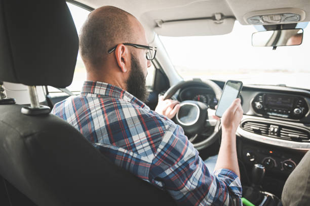 istock man traveling by car with smart phone 2075503040