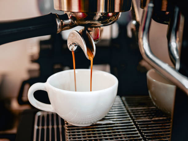 istock Coffee extraction from the coffee machine with a portafilter pouring coffee into a cup,Espresso poruing from coffee machine at coffee shop 2075507995