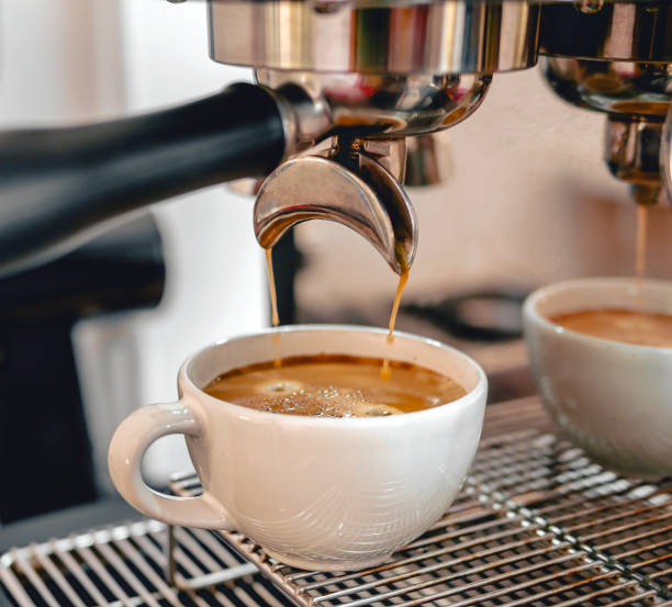 istock Coffee extraction from the coffee machine with a portafilter pouring coffee into a cup,Espresso poruing from coffee machine at coffee shop 2075508278