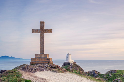 Ynys Llanddwyn Lighthouse and a plain cross at Ynys Llanddwyn, North Wales, Anglesey