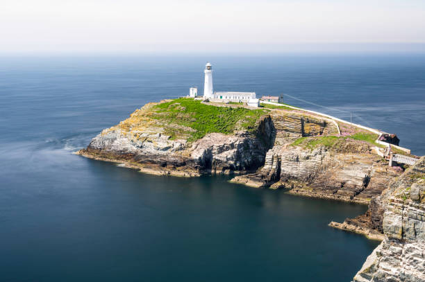 istock South Stack lighthouse, on Anglesey, north Wales. The lighthouse is located on a small island just off the mainland and is reached by a flight of very steep stairs. It is a bright summers day 2075517162