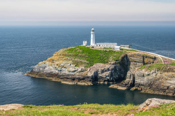 istock South Stack lighthouse, on Anglesey, north Wales. The lighthouse is located on a small island just off the mainland and is reached by a flight of very steep stairs. It is a bright summers day 2075517184