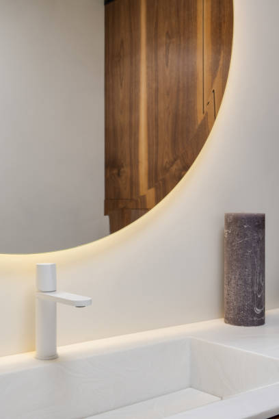 istock Wood sink fixture with round mirror in modern bathroom interior design 2075554128