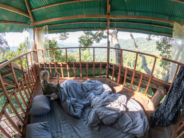 istock A woman wakes up in a tree house 2075556403
