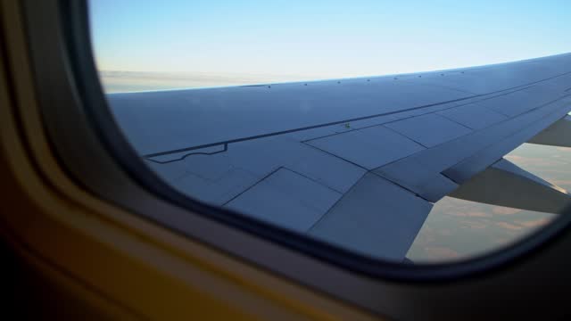 View Of A Plane Wing From An Airplane Window During The Flight