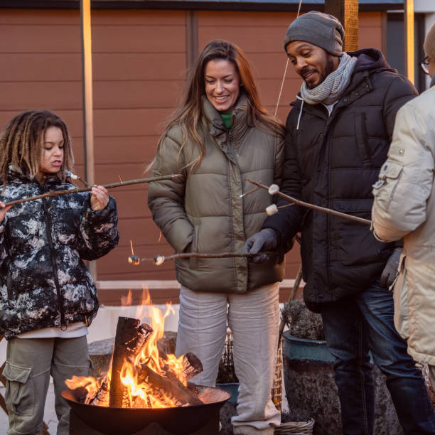 istock A happy family around a fire making marchmellows 2075567421